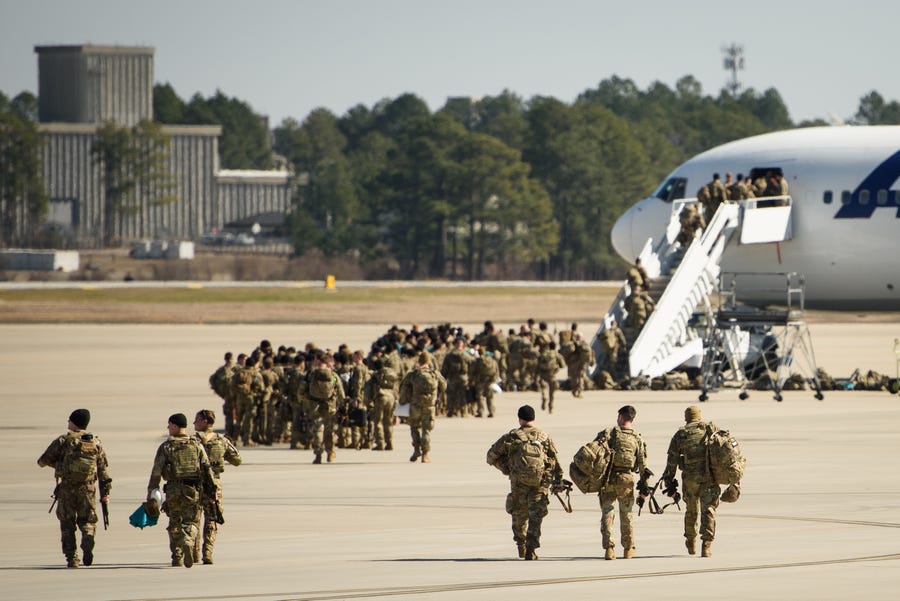 Paratroopers from Fort Bragg's 82nd Airborne Division board a plane on Feb. 14, 2022. They are among soldiers the Department of Defense is sending to Poland amid a growing Russian presence near Ukraine.
