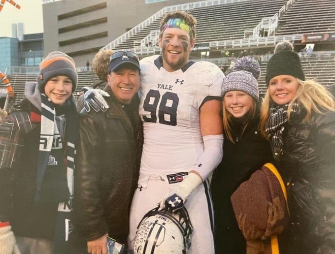 Kyle Mullen, while playing football at Yale, poses with family members at Princeton