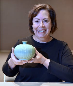 Mary Ellen Lemire, of Huntington Woods, poses with her 19-Century Asian vase, Friday, October 29, 2021, as
Metro Detroiters get their items appraised for the Trash or Treasure column at the Michigan Design Center in Troy.