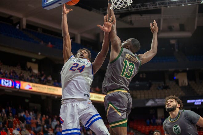 Boise State Broncos forward Abu Kigab (24) drives to the basket against Colorado State Rams guard Chandler Jacobs (13) during the second half of play at ExtraMile Arena on Feb. 13. Colorado State beat Boise State 77-74.