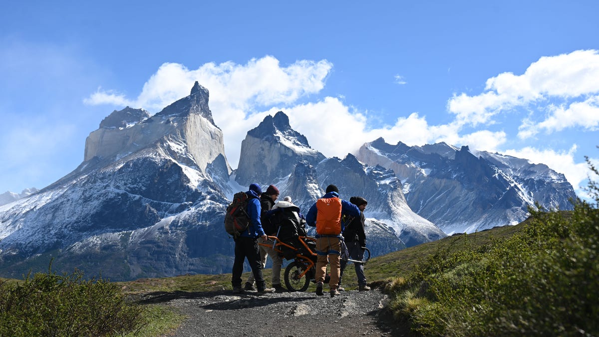On the Joelette wheelchair, Angelina Fanous, with the help of local guides, treks through Torres del Paine in Chilean Patagonia.