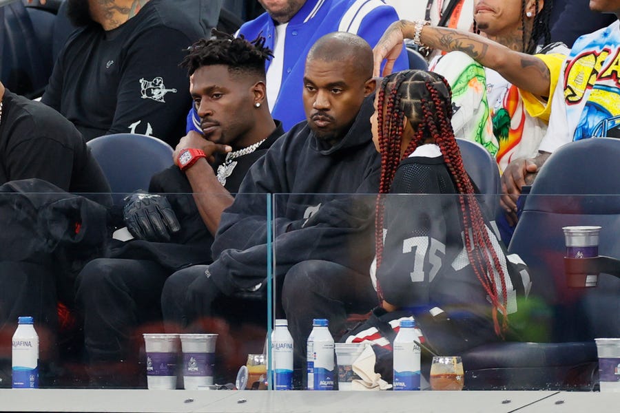 Antonio Brown, Kanye West and North West attend Super Bowl LVI between the Los Angeles Rams and the Cincinnati Bengals at SoFi Stadium on February 13, 2022 in Inglewood, California.