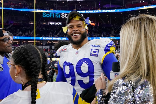 Los Angeles Rams defensive end Aaron Donald (99) smiles after defeating the Cincinnati Bengals at the NFL Super Bowl 56 football game Sunday, Feb. 13, 2022, in Inglewood, Calif. (AP Photo/Steve Luciano)