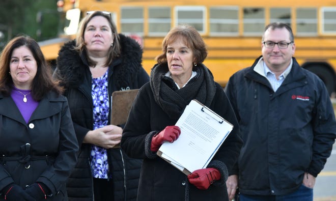 Anne-Marie Siroonian, center, previous Bourne School Committee president, holds an affidavit to begin a recall of Kari MacRae during a press conference across from the Bourne High School on Dec. 7. The recall election will not be held because town officials said not all of the signatures were properly filed.