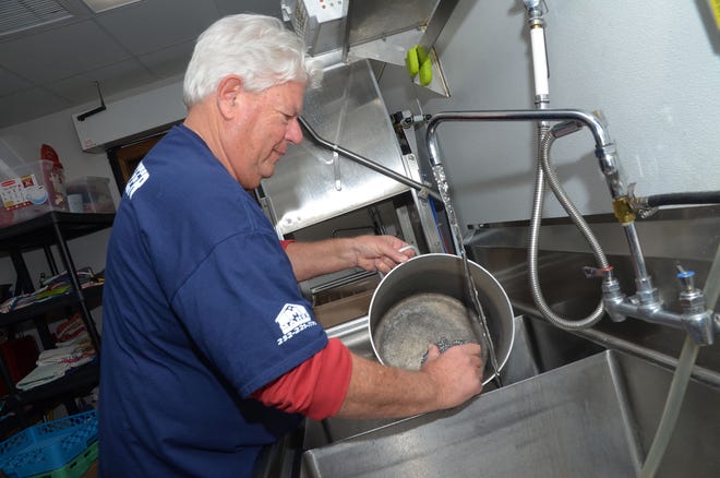 John Leahy, one of the longest-serving volunteers at Religious Community Services in New Bern, works in the New Bern nonprofit's kitchen washing dishes, a volunteer position he's held for the last 11 years.