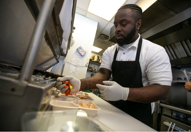 Fritz Georges prepares a meal in the kitchen of MacroBites at Kula Cafe in Asbury Park.