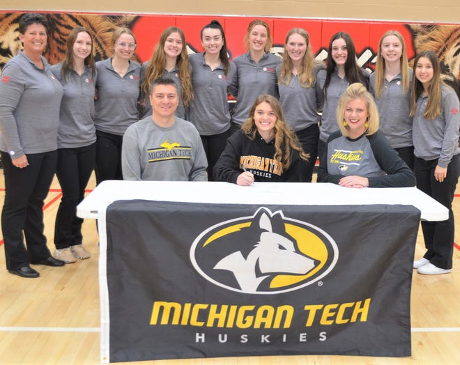 St. Philip standout Brooke Dzwik committed to play volleyball at Michigan Tech University during a signing ceremony at St. Philip High School on Tuesday. She is joined by her parents, Doug and Andrea Dzwik, head coach Vicky Groat and he Tiger teammates.