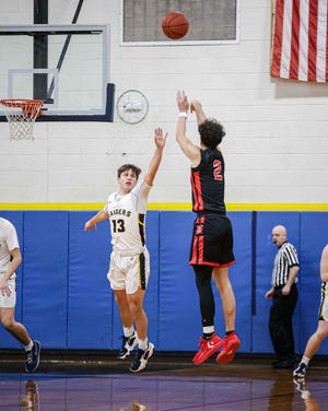 Miguel Pena (2) shoots a jumper from medium range as Dallas George (13) tries to put a hand in his face. Hempfield defeated ELCO 50-33 in an LL League Playoff game on February 14, 2022.