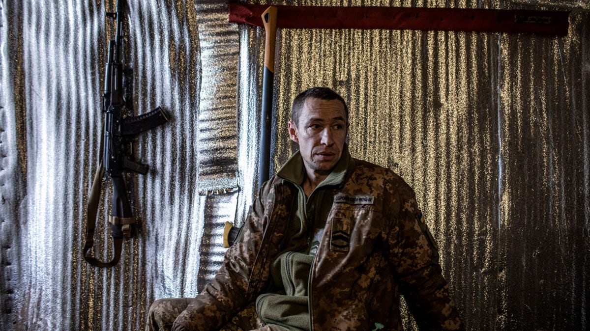 Prívate Pablo, 41, sits in an underground barrack at the position of his unit at the contact line near Svitlodarsk, in Donestsk region on February 13, 2022 in Svitlodarsk, Ukraine. Russian forces were conducting large-scale military exercises in Belarus, across Ukraine's northern border, amid a tense diplomatic standoff between Russia and Ukraine's Western allies.