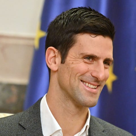 Novak Djokovic looks on as he attends a meeting wi