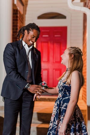 Before the Daddy-Daugher Dance, Philadelphia Eagles safety Anthony Harris places a corsage on Audrey Soape's right wrist. [FILE]