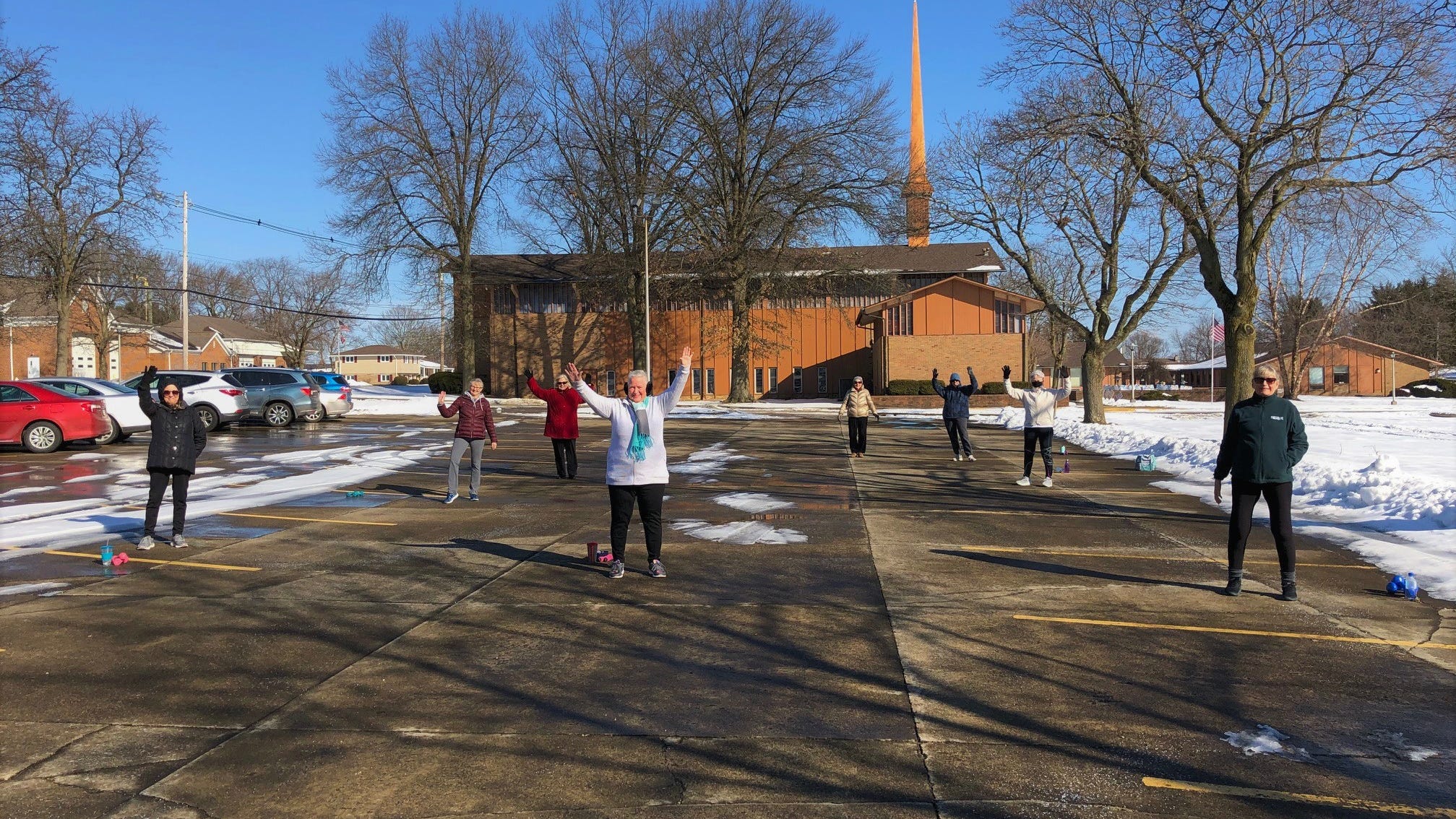 During the COVID-19 pandemic, YMCA fitness instructor Jenni Reusser has used a church parking lot to maintain her class.
