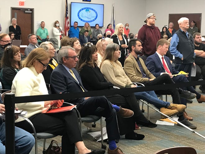 Tony Marlow,  second from left, Carolyn Marlow, third from left, Christopher Marlow, second from right and their attorney, John Ferguson at right, listen to Palm Coast City Council on Tuesday. The Marlows own the Green Lion in Palm Coast and the Golden Lion in Flagler Beach.