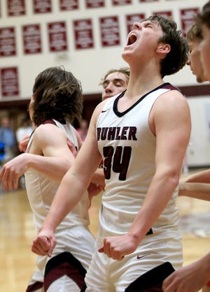 Buhler's Jack Voth (34) celebrates as the Crusaders tied the game against McPherson Tuesday, Feb. 15, 2022 at the Jim Baker Fieldhouse. Buhler defeated McPherson 68-61 in overtime.