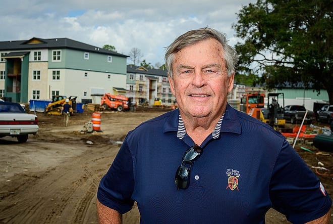 St. Johns County Commissioner Henry Dean stands in front of the San Marcos Heights apartments under construction off State Road 207 on Wednesday, Feb. 16, 2022. Dean proposed that voters decide whether to increase the county’s sales tax by 1 cent to help mitigate the county’s infrastructure needs caused by the area’s rapid population growth. The increase would go from 6.5 cents on the dollar to 7.5 cents for 10 years and bring in about $500 million.
