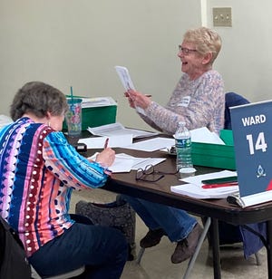 Poll workers count early ballots Tuesday at Green Bay City Hall.