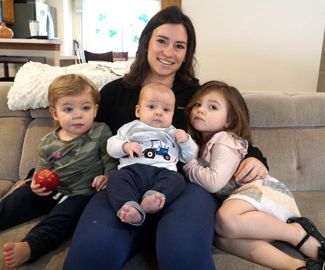 Marisa O'Neill and her three children survived a rollover crash on Interstate 275 near Six Mile Road Feb. 9. O'Neill is searching for two men who came to her aid but left the scene before she could thank them. From left are O'Neill's children Benjamin, 1, Matthew, 2 months, and Isabella, 3.