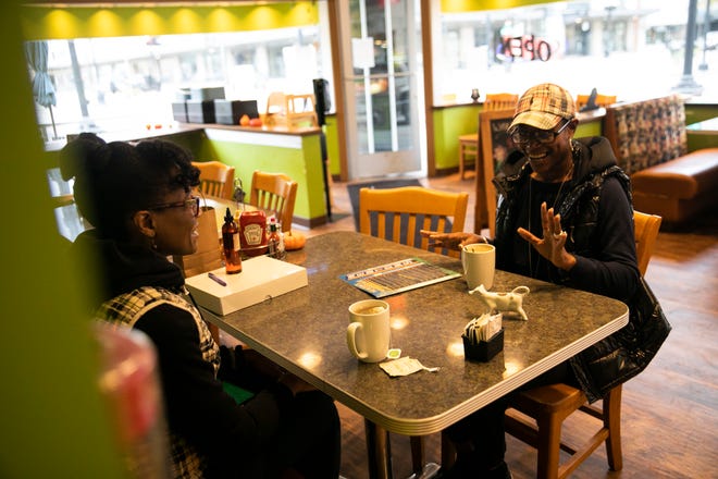 ReShonda Young talks with business owner Rosie Daniel of LuLit’s Hair Essence at Newton’s Paradise Cafe in Waterloo, Iowa, on Oct. 27, 2021.