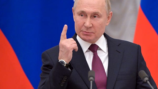 Russian President Vladimir Putin gestures as he sp
