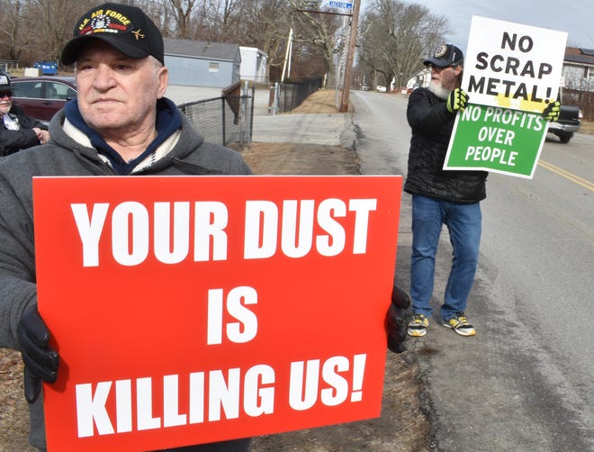 Somerset residents Ed Faria and Dan Medeiros outside Brayton point. They say they don't care what is done with the site as long as the scrap metal is removed and dust and odors stop.