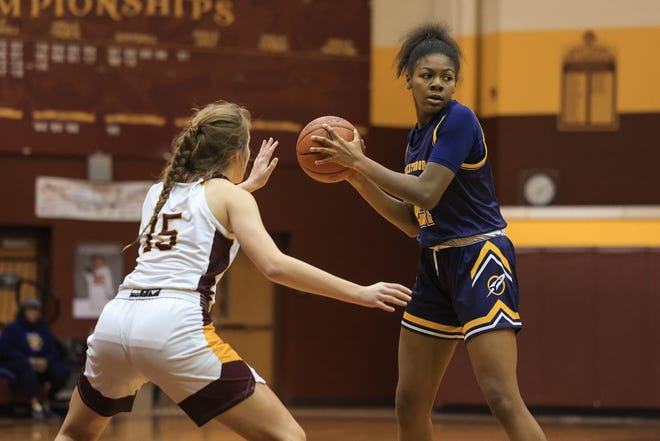Streetsboro freshman Naomi Benson scans the floor while Southeast senior Abaigeal Fischer guards during Wednesday night's first-round playoff game at Southeast High School.