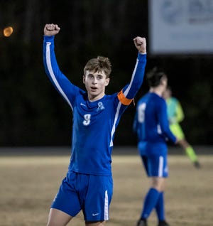 Marlin Braden Masker raises his arms to celebrate after the final whistle blew. Arnold hosted Gulf Breeze in boys Regional soccer finals at Gavlak Stadium Wednesday, February 16, 2022. The Marlins were winners 3-1 over the Dolphins.