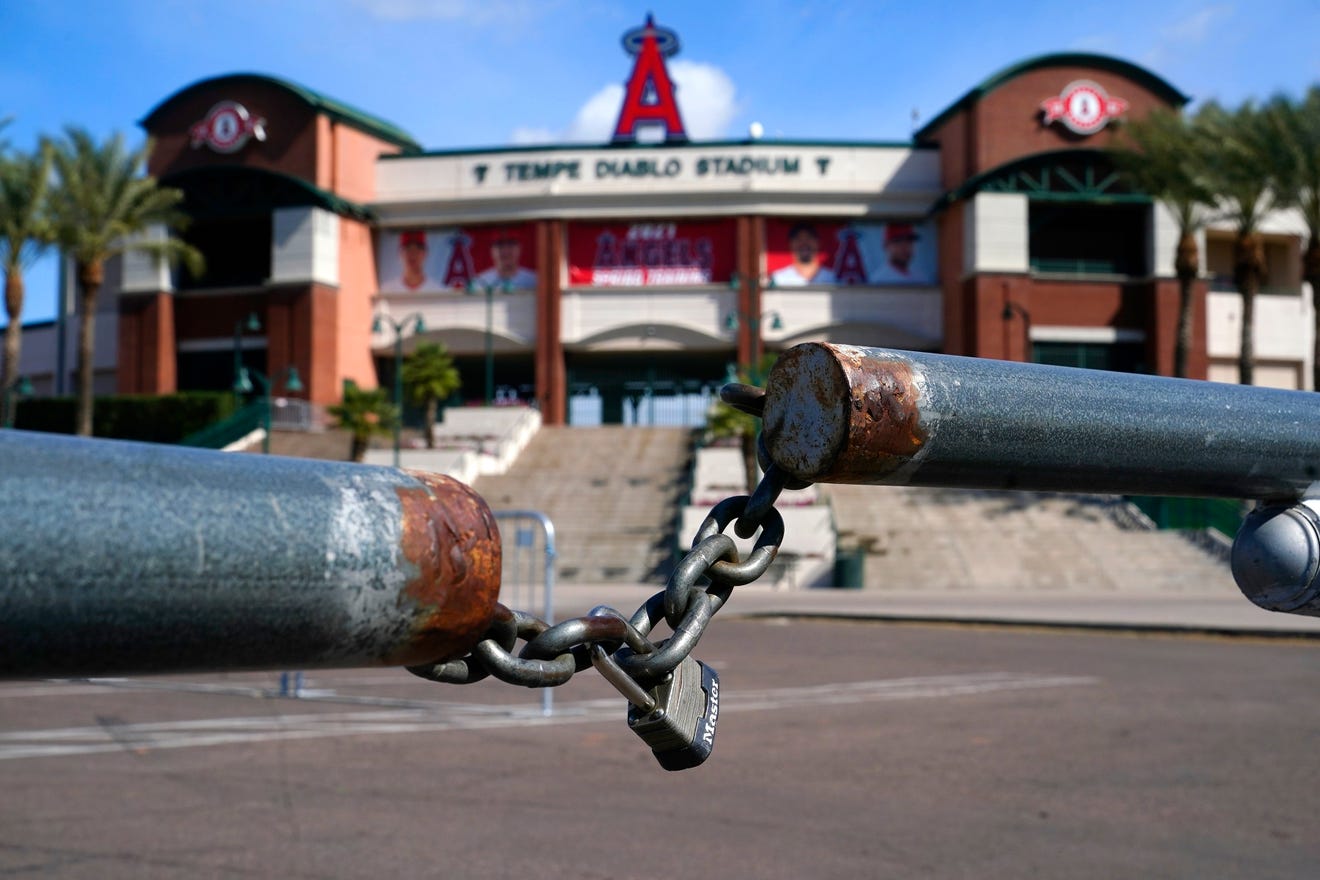 The main parking lot at the Los Angeles Angels Tempe Diablo Stadium remains closed as pitchers and catchers are not starting spring training workouts as scheduled as the Major League Baseball lockout enters its 77th day and will prevent pitchers and catchers from taking the field for the first time since October in Tempe, Ariz., Wednesday, Feb. 16, 2022.