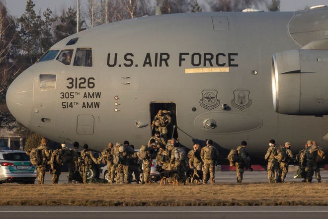 US soldiers disembark from a C-17 Globemaster cargo plane on the tarmac of Rzeszow-Jasionka Airport, southeastern Poland, on Feb. 16, 2022. Dozens of US paratroopers landed there as part of a deployment of several thousand sent to bolster NATO's eastern flank in response to tensions with Russia.