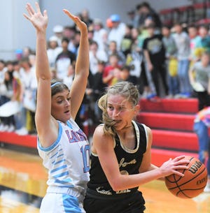 Borden County's Kambell Schmidt, left, pressures Jayton's Daylee Chisum in a Class 1A area playoff Thursday at Lubbock-Cooper High School in Woodrow.