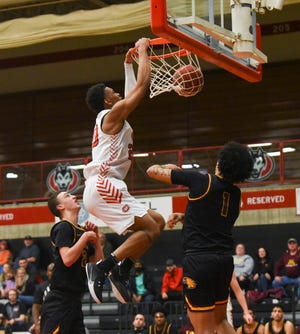 St. Cloud State junior Caleb Donaldson dunks the ball Thursday, Feb. 17, 2022, at Halenbeck Hall in St. Cloud. A 76-71 victory over Crookston on Thursday night clinched a spot for SCSU in the NSIC tournament next week.