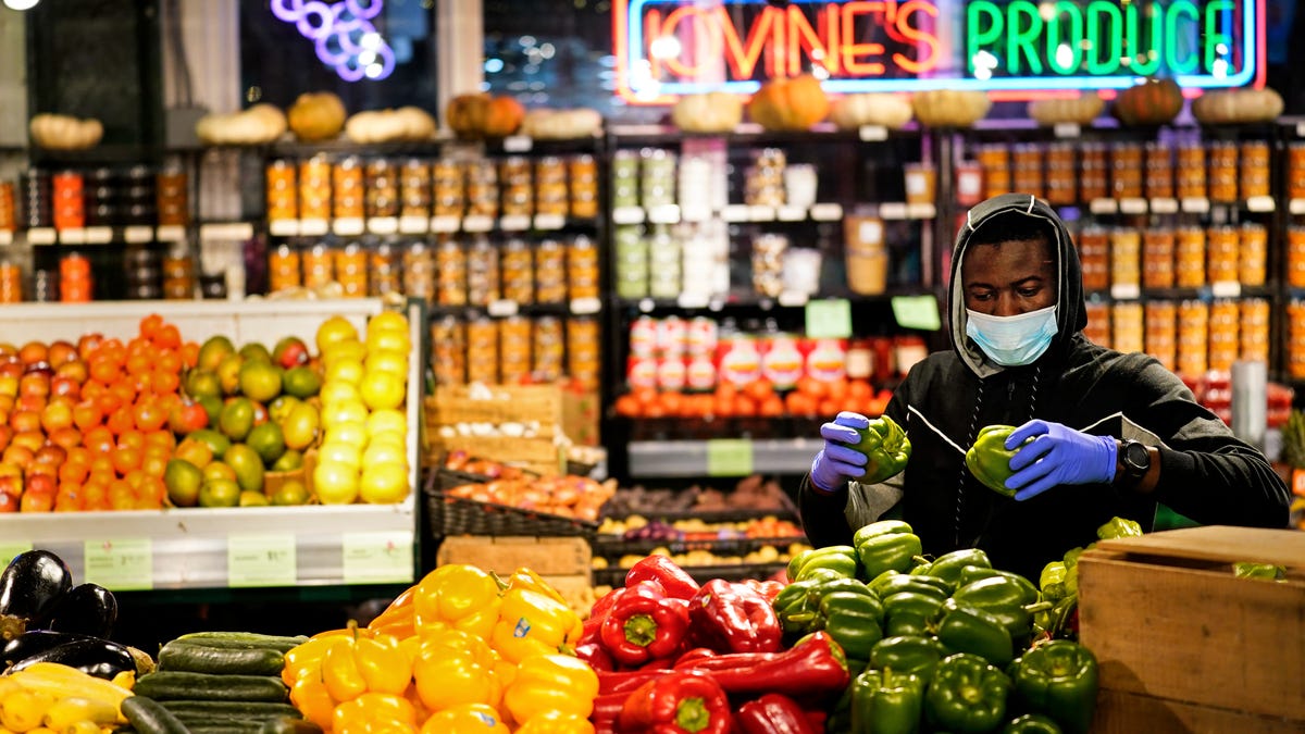 A grocer stocks the Reading Terminal Market in Philadelphia on Feb. 16. Officials lifted the city's vaccine mandate for indoor dining and other establishments that serve food and drinks, though mask requirements remain in place.