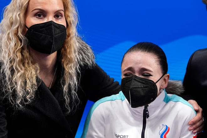 Russian coach Eteri Tutberidze puts her arm around Kamila Valieva after her disastrous free skate Thursday night at the Winter Olympics.