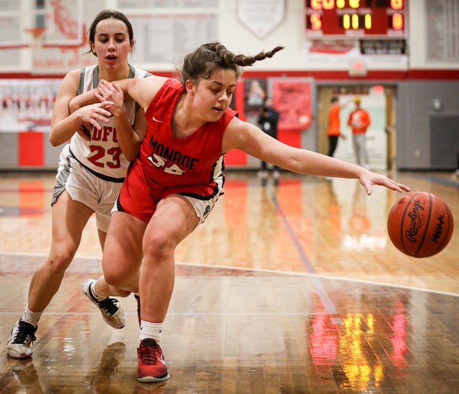 Monroe’s Sophia Bussell reaches for a loose ball against Kerstin Nadolny of Bedford during a 61-23 Bedford win Friday night.