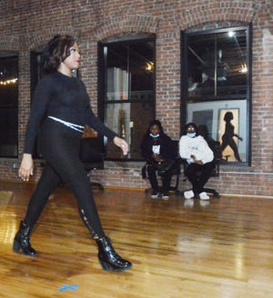 Shella Jeanty, coordinator for Black History Month Vendor Fair and Fashion Show shows her runway walk to models during a casting call at the Sunlight Building at Foundry 66. The event will begin at 1 p.m. in downtown Norwich on Feb. 26, with the fashion show starting at 5:45 p.m.