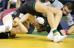 South Kitsap's Stone Hartford battles Kentwood's Adriano Perez during the first day of Mat Classic on Friday at the Tacoma Dome.