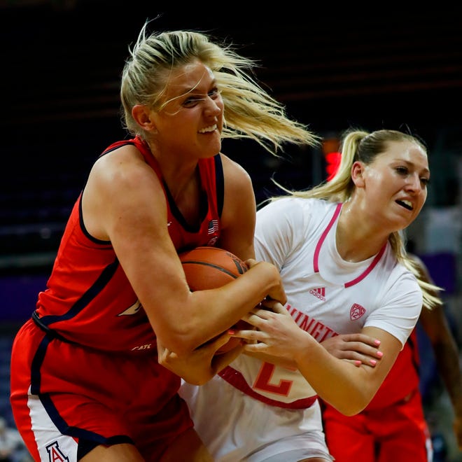Arizona forward Cate Reese, left, takes the ball away from Washington forward Lauren Schwartz during the first quarter of an NCAA college basketball game Friday, Feb. 18, 2022, in Seattle. (Jennifer Buchanan/The Seattle Times via AP)