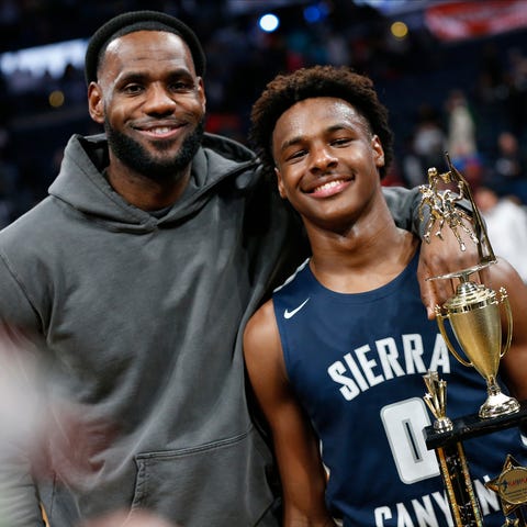 LeBron James, left, poses with his son Bronny afte