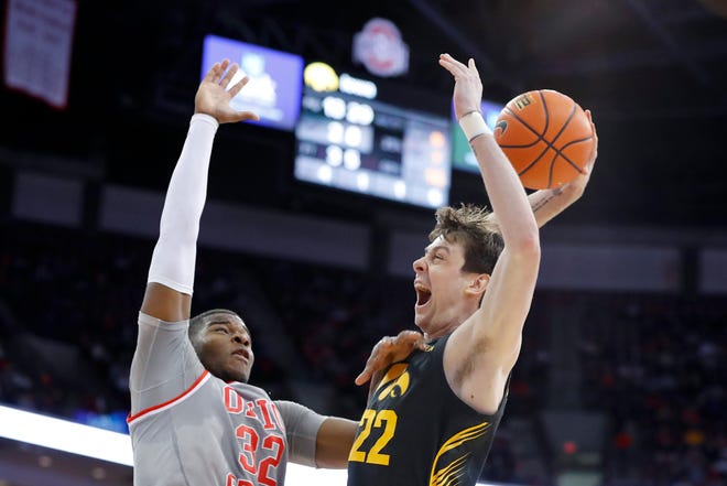Iowa Hawkeyes forward Patrick McCaffery (22) goes for the dunk as he gets his shot blocked by Ohio State Buckeyes forward E.J. Liddell (32) during the first half at Value City Arena.