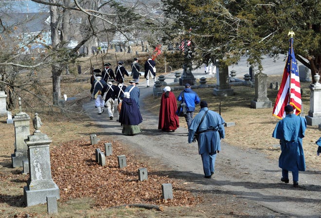 The Hingham Militia and the 54th Massachusetts Regiment wend through Hingham Cemetery during the Lincoln Day celebration in Hingham, Saturday, Feb. 19, 2022.