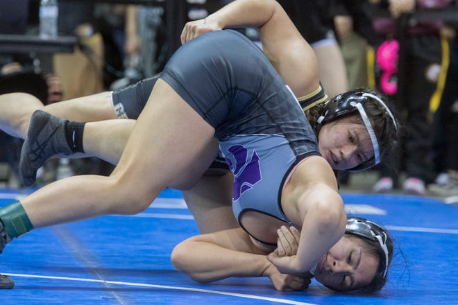 Chavez's Taydem Khamjoi, top, grapples with Tokay's Cynthia Isordia in the 137-lb. class during the second day of the Sac-Joaquin Section Masters wrestling tournament at the Stockton Arena in downtown Stockton. 