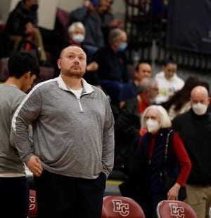 Seton assistant coach Cody Dudley looks up at the scoreboard before the start of the second half against Lincoln Feb. 19, 2022, at Earlham College.