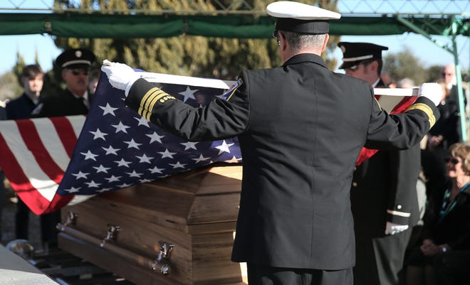 San Angelo Fire Department personnel prepare to fold up the American flag on former San Angelo Fire Chief Daryl Eddy's casket during graveside services at Lawnhaven Memorial Gardens on Saturday, Feb. 19, 2022.