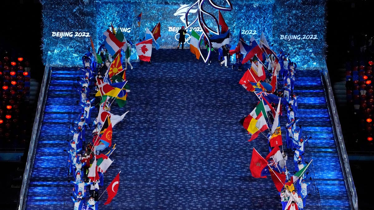 The flags of the participating Olympic countries are carried during the closing ceremony for the Beijing 2022 Olympic Winter Games at Beijing National Stadium.