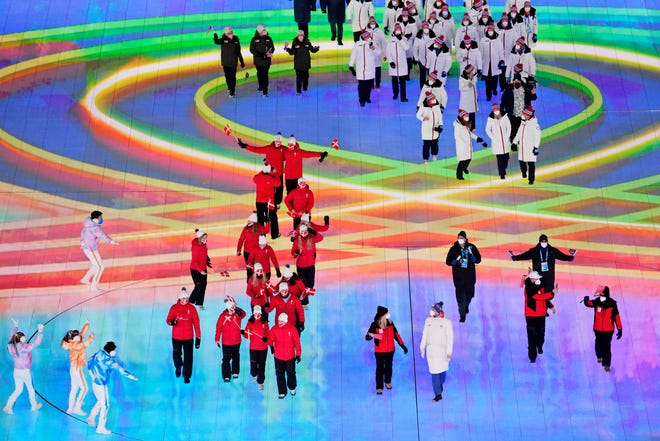Olympic athletes enter the arena during the closing ceremony for the Beijing 2022 Olympic Winter Games at Beijing National Stadium.