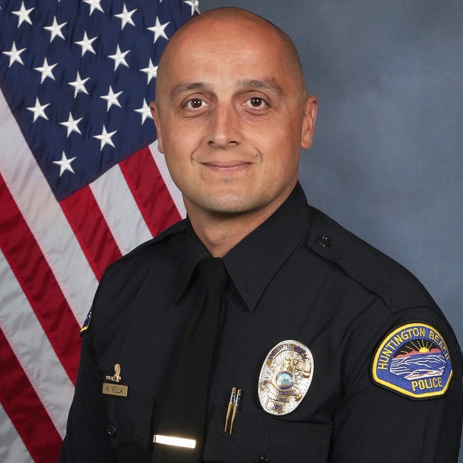 This photo provided by the Huntington Beach Police Department shows officer Nicholas Vella. Authorities say Vella was killed, Saturday, Feb. 19, 2022, and another officer was critically injured after a police helicopter crashed in water near California's coast. Vella was a 14-year veteran with the department.