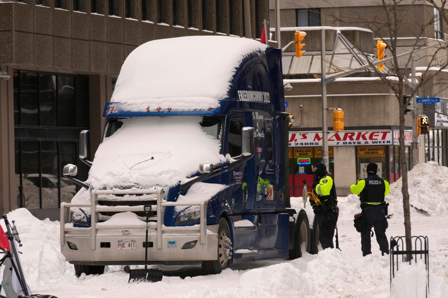 Police inspect one of the last remaining trucks in downtown Ottawa on Sunday, Feb. 20, 2022. A protest, which was first aimed at a COVID-19 vaccine mandate for cross-border truckers but also encompassed fury over the range of COVID-19 restrictions. 