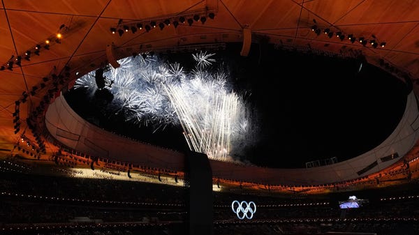 A fireworks display over the Olympic rings during 