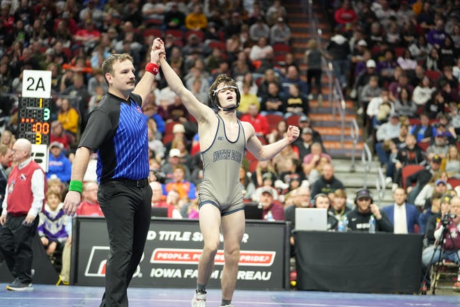 Notre Dame-West Burlington senior Blaine Frazier has his had raised after winning the Class 2A 132-pound state championship Saturday at Wells Fargo Arena in Des Moines.