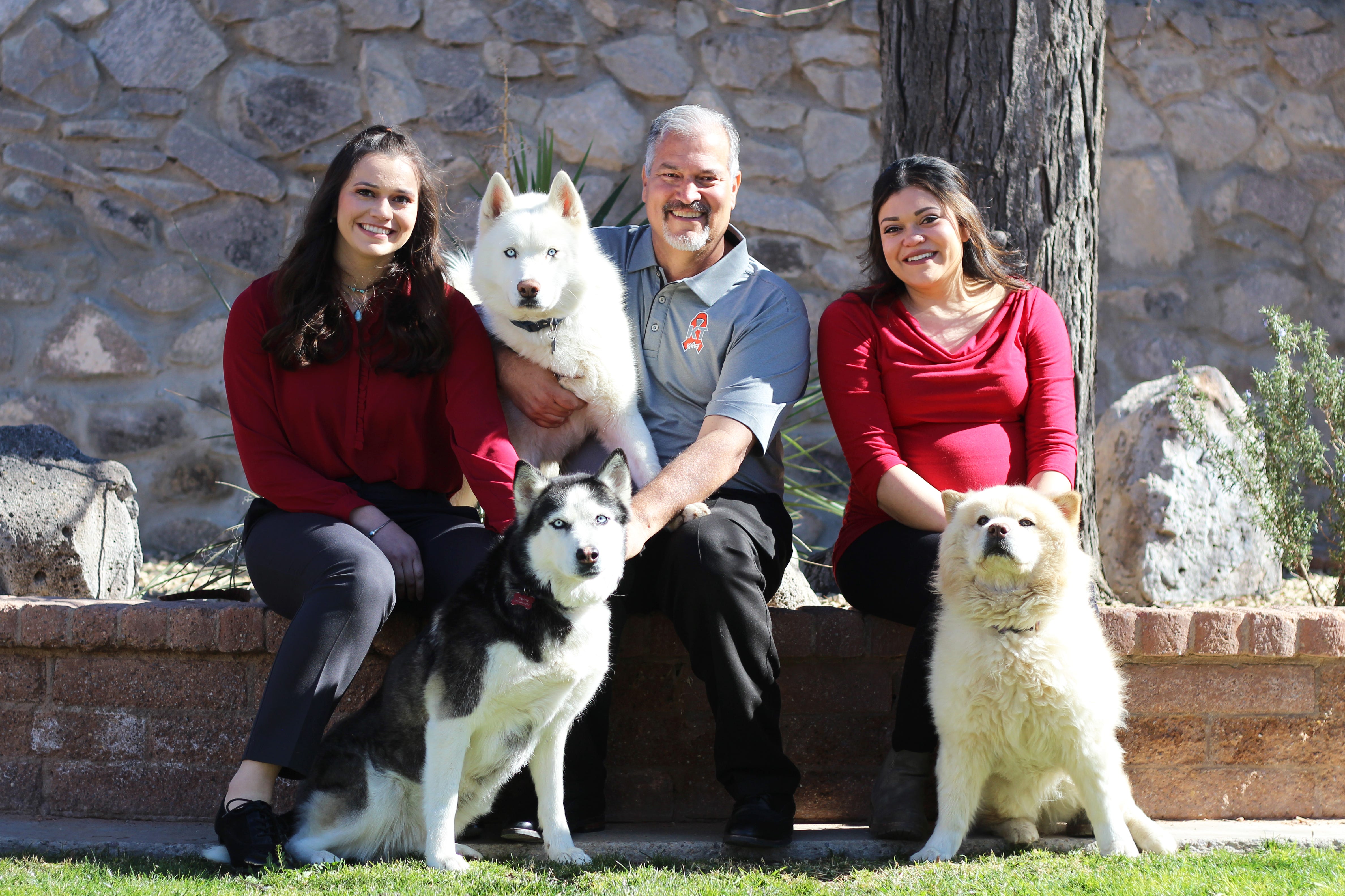 Karen Trujillo's husband, Ben Trujillo and their two daughters Taralyn and Tavyn pose with their three dogs in the backyard of their family home in January 2022.