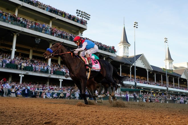 John Velazquez rides Medina Spirit across the finish line to win the 147th running of the Kentucky Derby at Churchill Downs in Louisville, Ky., May 1, 2021. The horse was stripped of that victory on Monday.